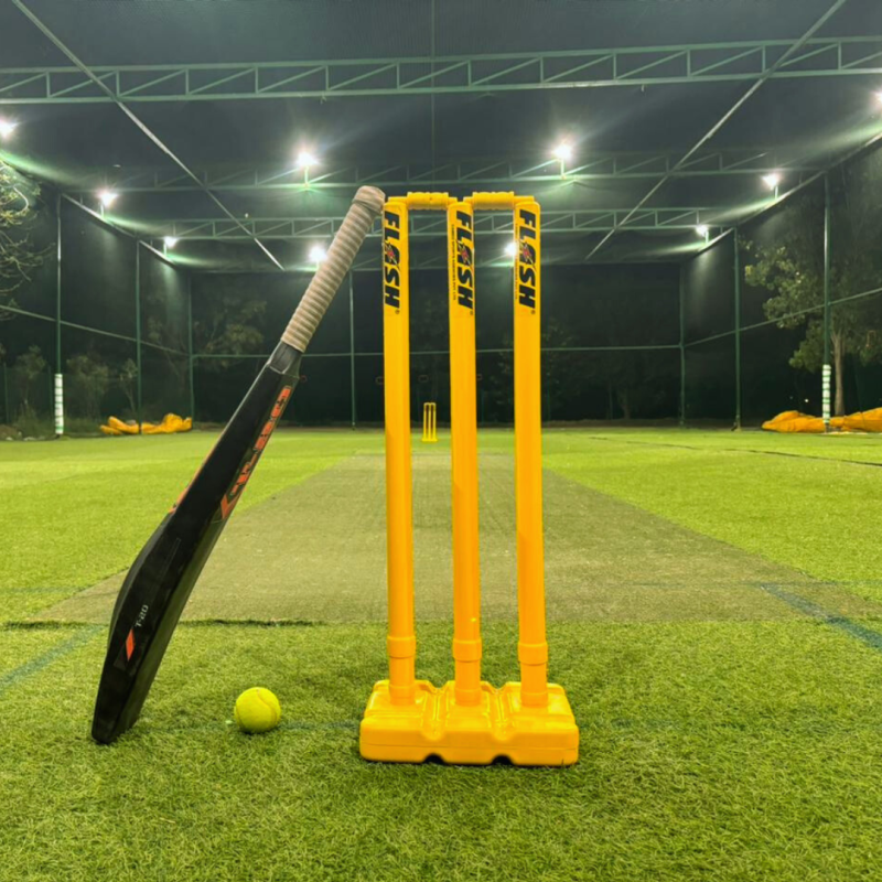 Match-ready stumps, bat and ball on the turf